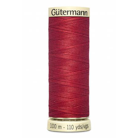 spool of gutermann thread, color light cranberry