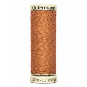 spool of gutermann thread, color burnt orange